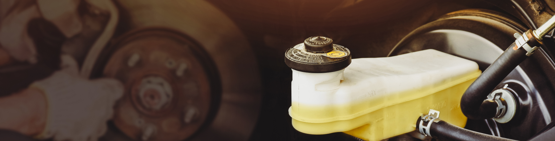 Image of a brake fluid reservoir of a car brake system with a disc brake.