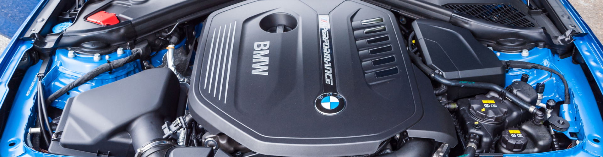 An open hood for a 2017 BMW M140i.