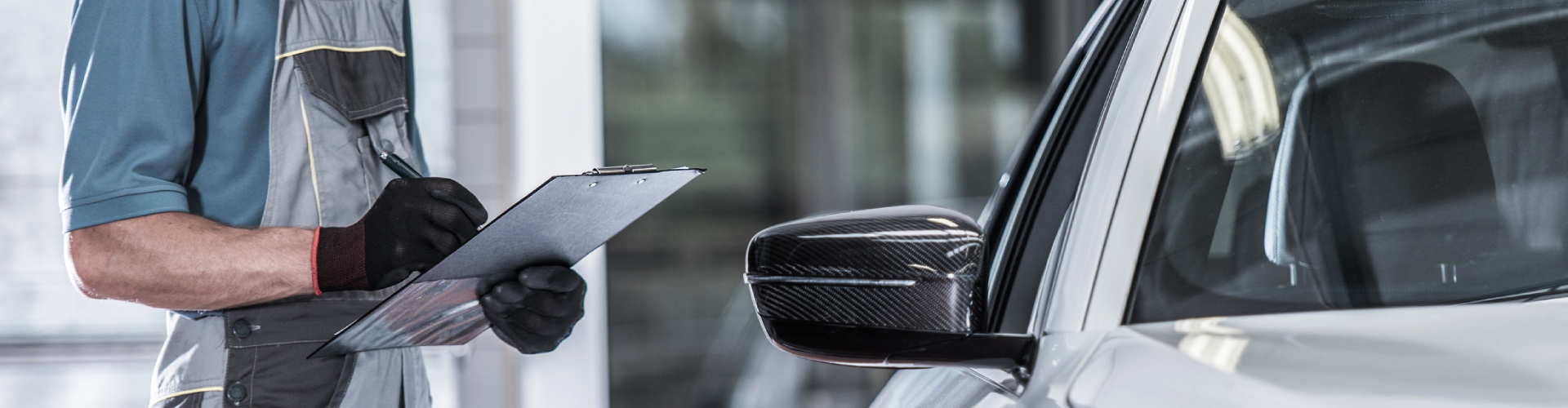 An auto mechanic completing a pre-purchase inspection for a BMW.