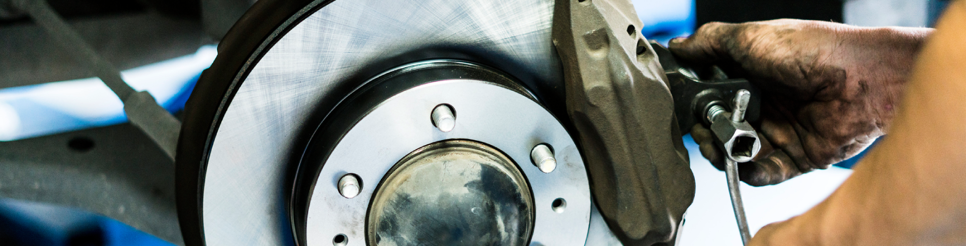Mechanic assembles brake disc during Audi brake service.