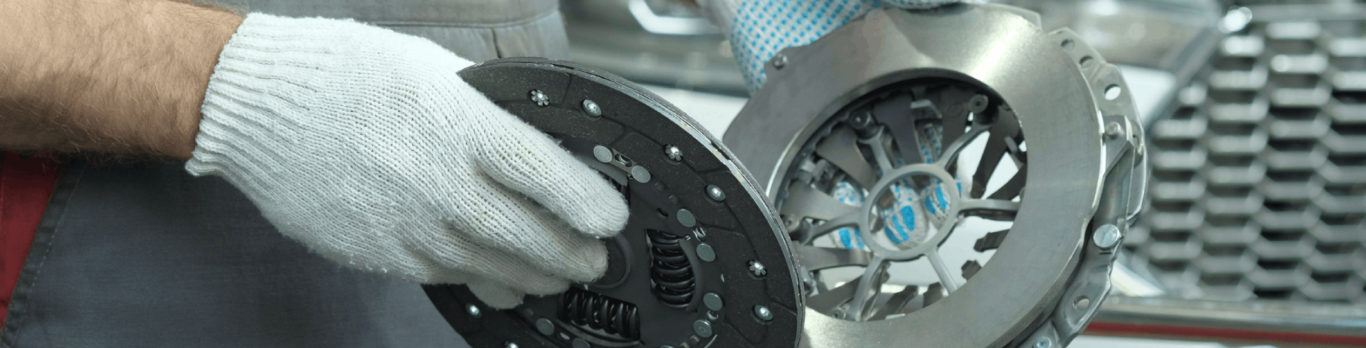 An auto mechanic inspects the technical condition of MINI Cooper clutch replacement before installation.
