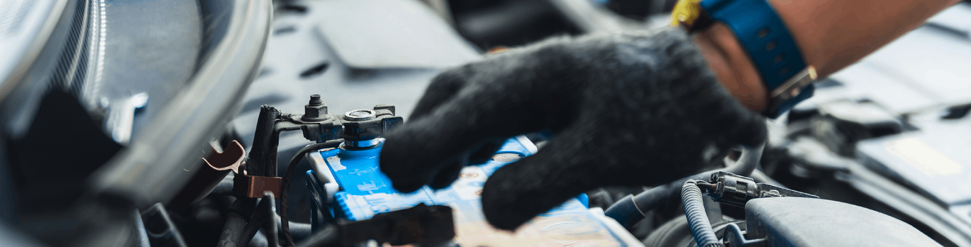 Mechanic replaces battery for Mercedes-Benz, close-up.