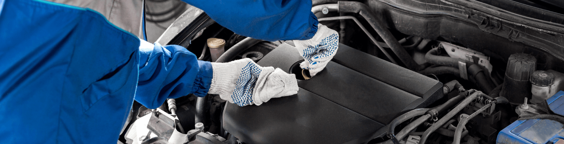 A mechanic checking the oil level during Mercedes oil change.