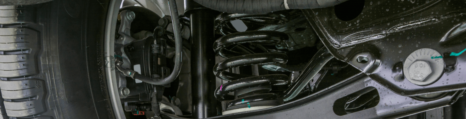 A modern car’s suspension system, viewed from underneath the vehicle.