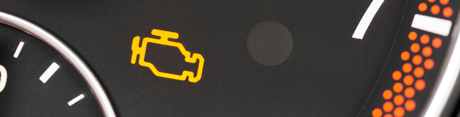 Close up, check engine light illuminated on Mercedes dashboard.