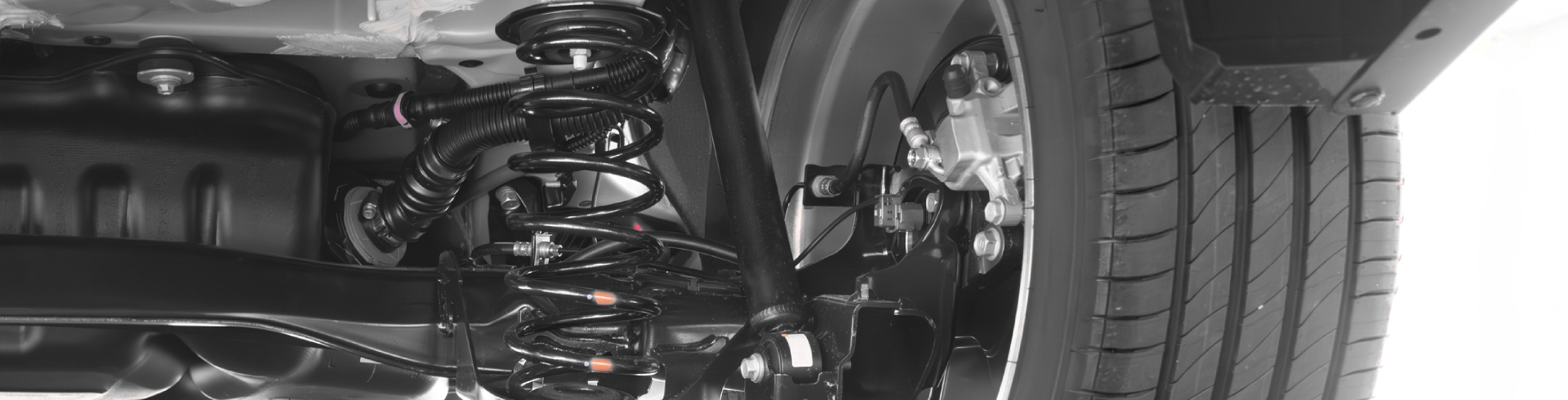 Silver Mercedes suspension, viewed from under the vehicle.