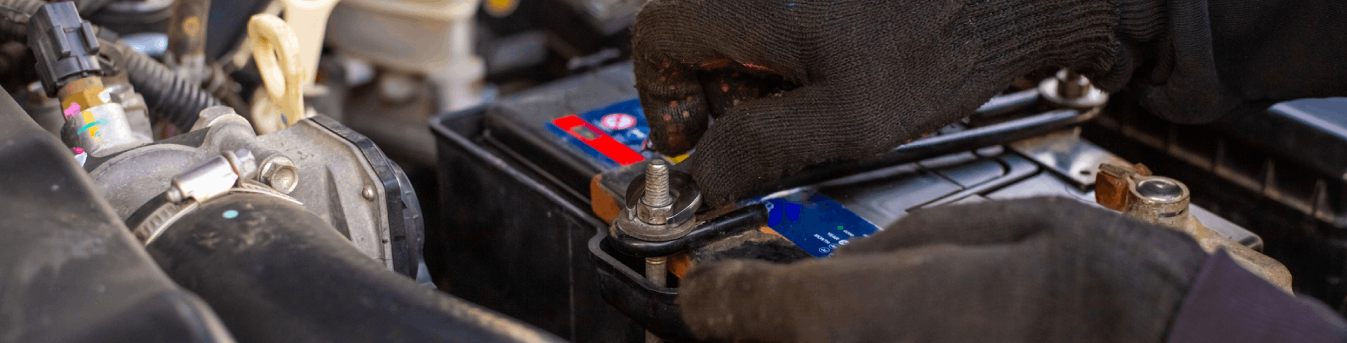 MINI auto technician installs new battery.