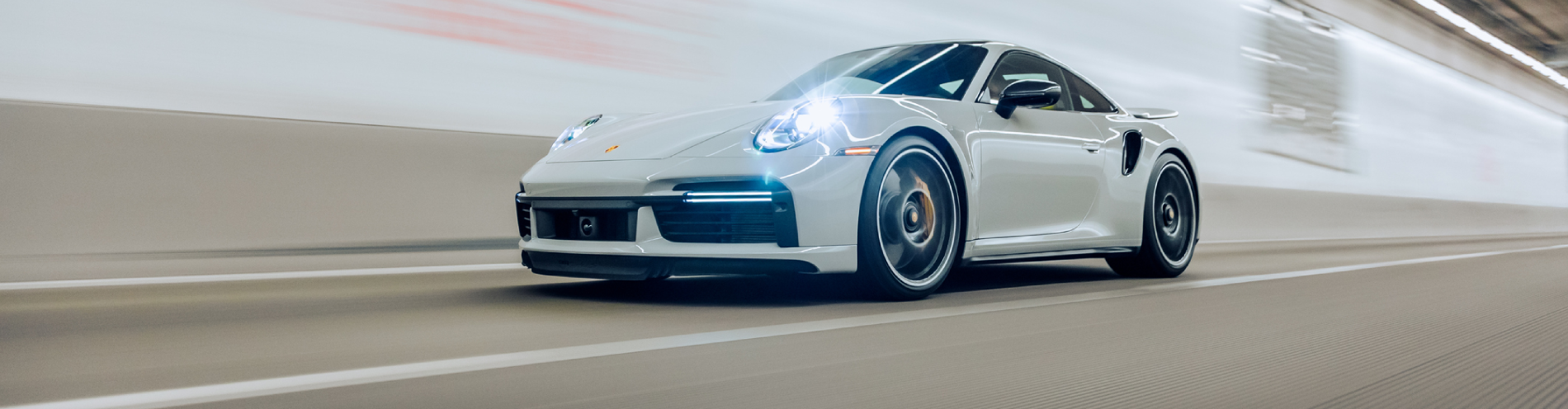 Porsche 911 Turbo S driving in a tunnel with lights on